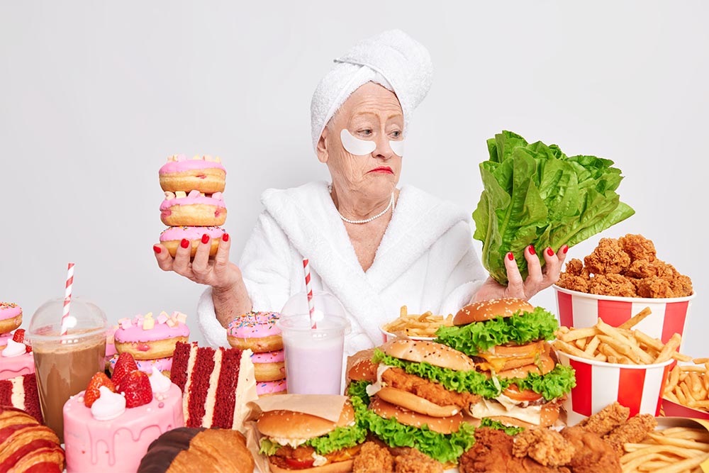 hesitant woman pensioner hesitates healthy unhealthy food holds doughnuts green vegetable