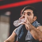 handsome young asian man sitting on modern gym and 2025 04 02 15 52 33 utc 1